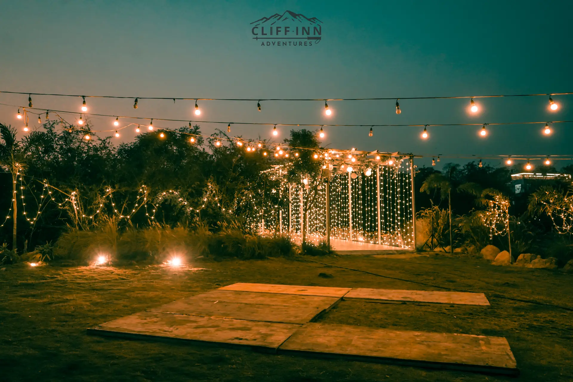 Campsite under fairy lights and open night sky